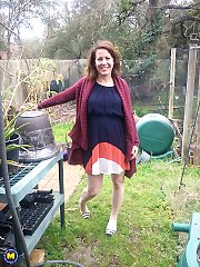 Naughty American MILF fooling around in the garden without panties