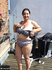 Kinky mature slut naked on a roof