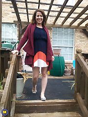 Naughty American MILF fooling around in the garden without panties