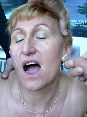 Horny mature slut sucking two guys in the woods