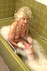 Very old granny taking a bath